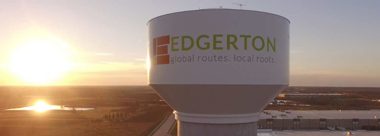 The water tower in Logistics Park Kansas City with the City of Edgerton's logo as the sun sets in the background