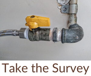 A water line with a yellow shut off valve. The words take the survey are underneath