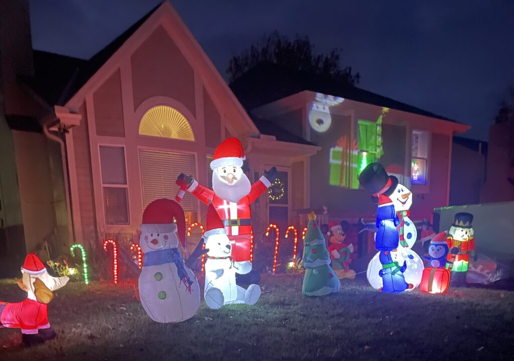 Inflatables cover the lawn while light up candy canes sparkle in the background
