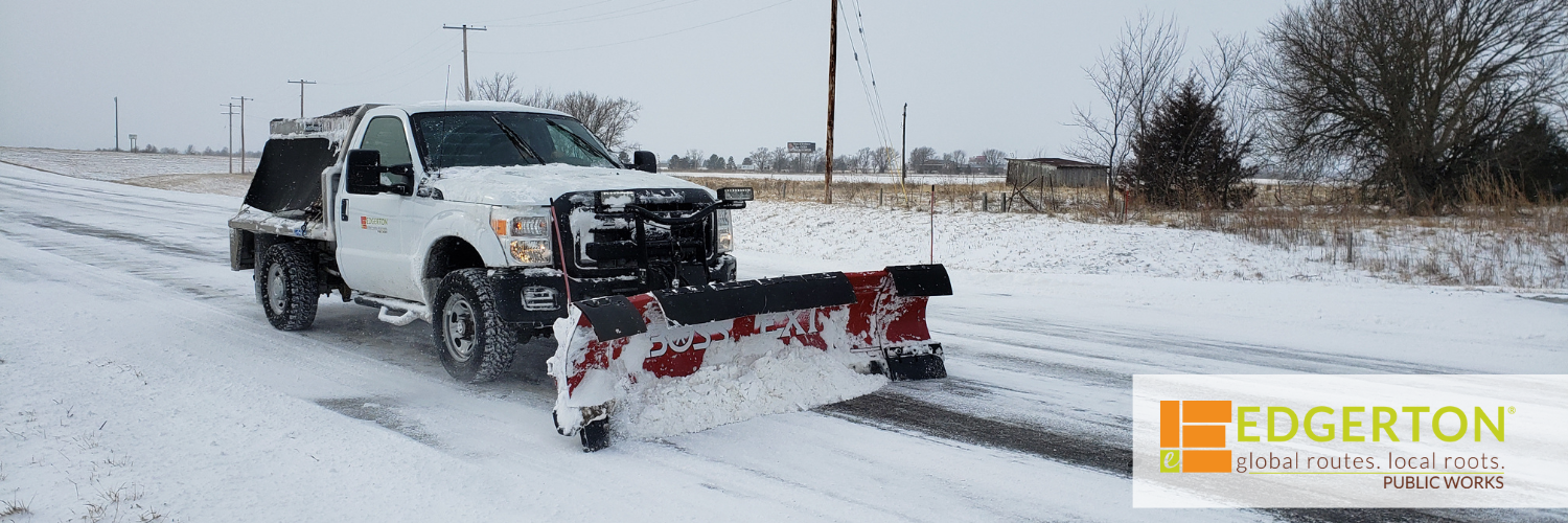 A plow pushes snow on Sunflower Road in Edgerton