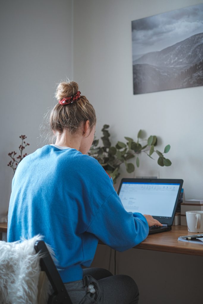 A woman works on her computer at home.