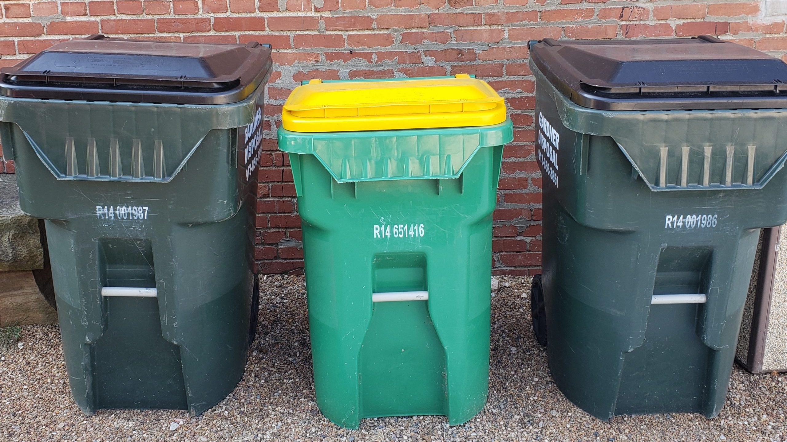 Two garbage cans and recycling bin